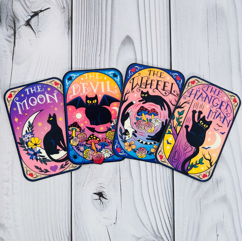 Four of the cat tarot stickers, the moon, the little devil, the wheel and the hanged man