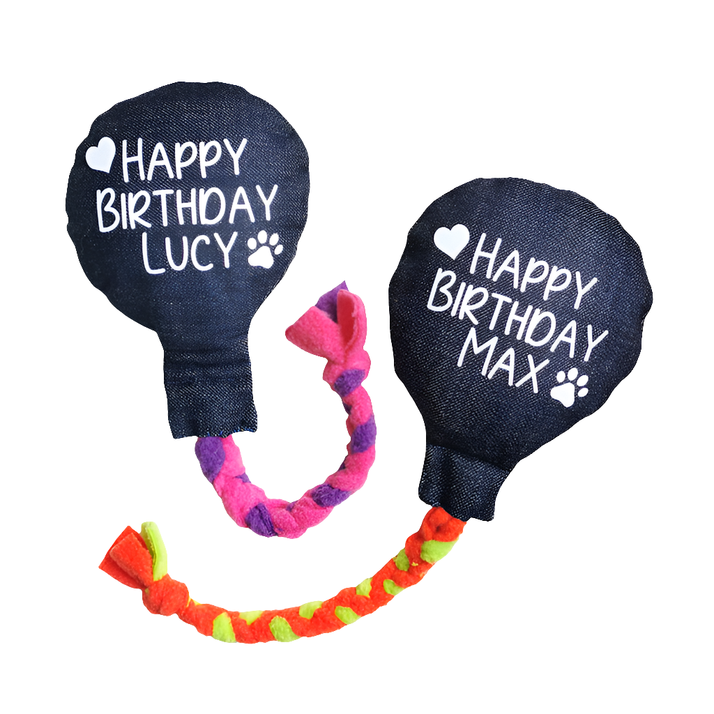 Picture shows two denim dog birthday balloons, one with a pink and purple fleece rope and the other with a green and orange one
