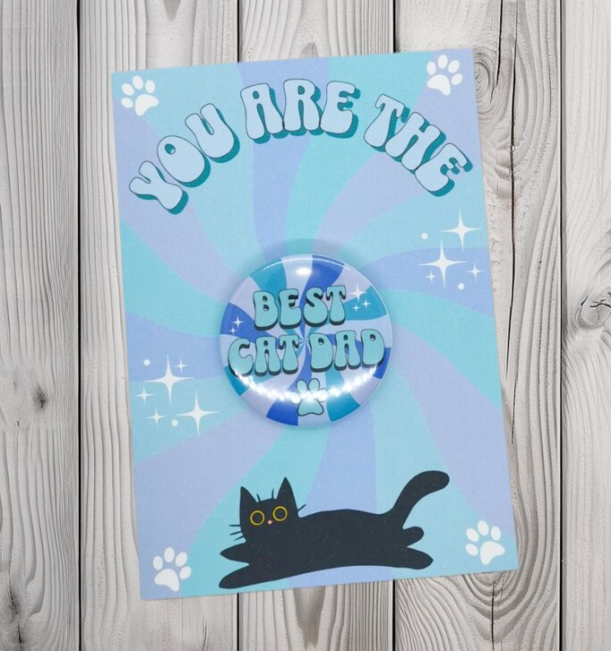 Picture shows a greeting card with a best cat dad badge attached, the card is perfect for father's day