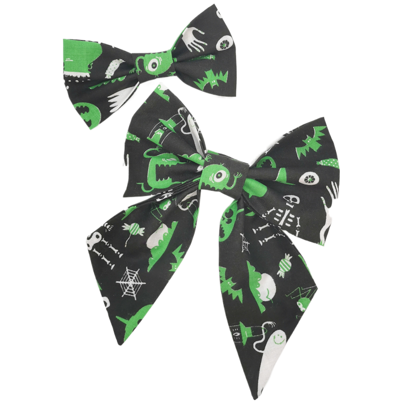 Photo shows a gorgeous pet sailor bow and bowtie made from hilarious black and green alien fabric, perfect for any stylish gift for cats and dogs for Halloween