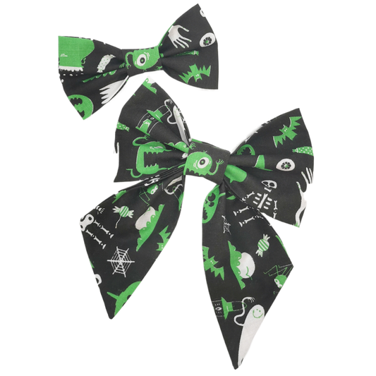 Photo shows a gorgeous pet sailor bow and bowtie made from hilarious black and green alien fabric, perfect for any stylish gift for cats and dogs for Halloween