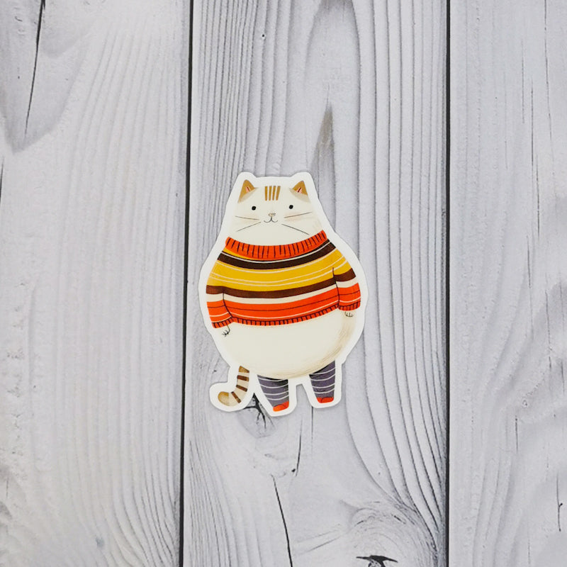 High quality, high gloss vinyl sticker which shows a chubby cat dressed in a jumper 