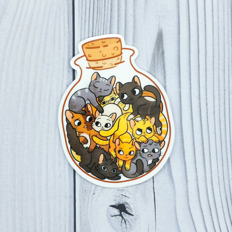 A sticker showing a group of cats in a bottle, the cats are all different colours, great gift for cat lovers