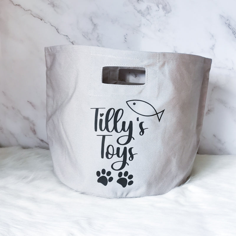 photo shows one singular pet storage tote with the words tilly's toys on, this storage tote would be perfect for a cat owner to store their cats toys in