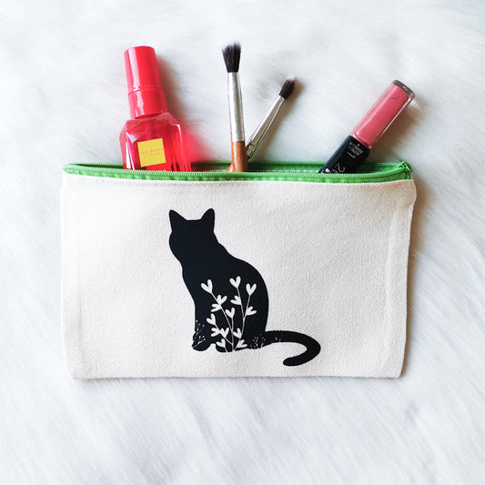 photo shows a make-up bag which depicts a sitting floral cat, the make-up bag is spacious enough to hold accessories and make-up and would make a great gift for any cat lover