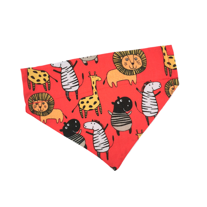 photo shows an over the collar pet bandana in the red safari animals fabric, the fabric is high quality, durable and easy to clean along with looking stylish and cute for your pet, this bandana would be great for a pet instagram photo shoot in the summer