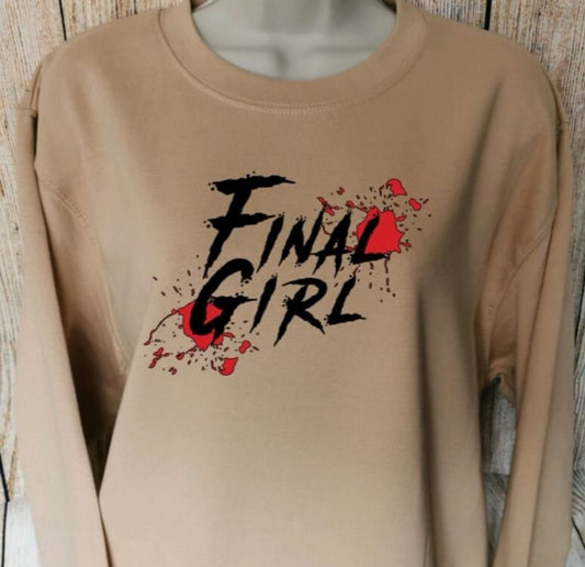 a sweatshirt in the colour nude with the words final girl on and blood splatters, the sweatshirt is perfect for horror film lovers