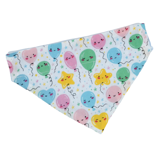 Picture shows a pet bandana which is made from pastel birthday balloon fabric, the balloons have kawaii faces on, this bandana is a perfect gift for cats and dogs on their birthday 