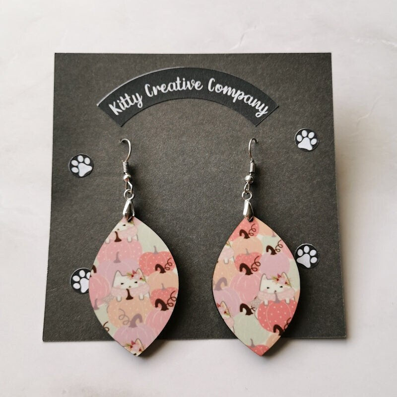 Photo shows the earrings on a black backing card with "Kitty Creative Company" written over the top and paws on, perfect for gifting