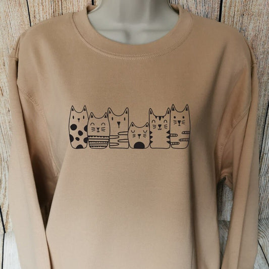 a sweatshirt for cat lovers in the colour nude which shows six different cats lined up