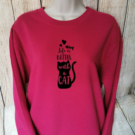 a sweatshirt for cat lovers in the colour cranberry that says life is better with a cat