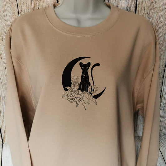 a sweatshirt for cat owners in the colour nude which has a sphynx cat sat on a moon with flowers