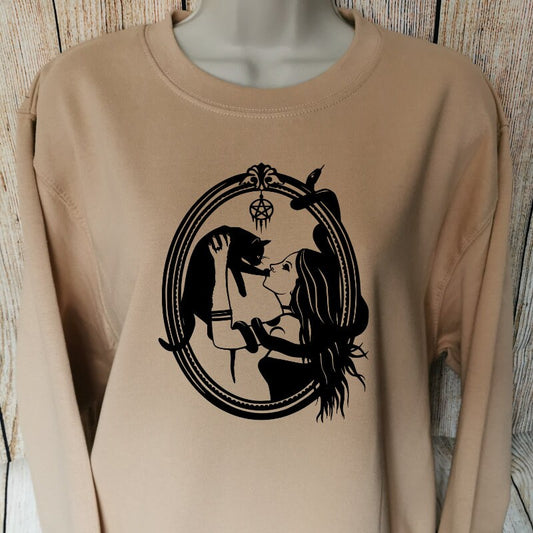 a sweatshirt in the colour nude which shows a gothic girl in a picture frame holding a black cat