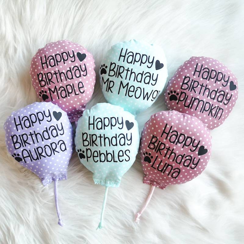 Catnip Cat toys in the shape of birthday balloons in three different colours, pink, green and lilac