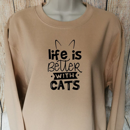 a sweatshirt for cat lovers in the colour nude which has the words life is better with cats on 